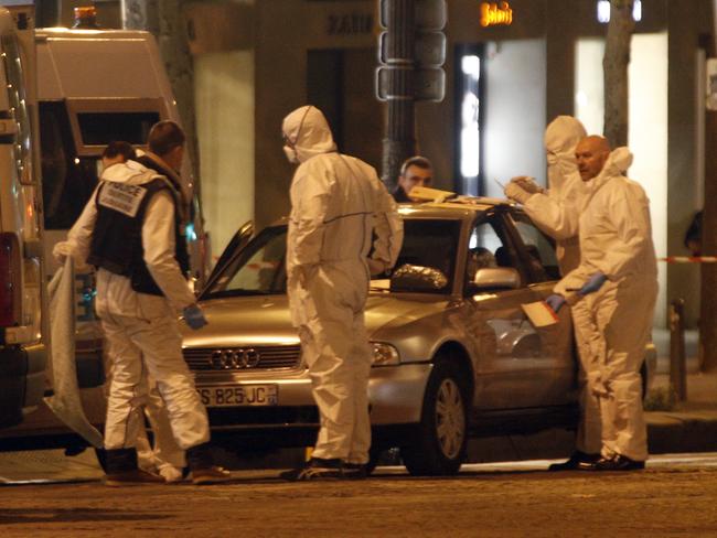 Forensic experts collect evidences from Audi belonging to an attacker who killed a police officer on the Champs Elysees avenue in Paris.