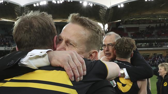 Chigwidden hugs coach Mark Stone after the win — with club great Peter Carey in the background. Picture SARAH REED