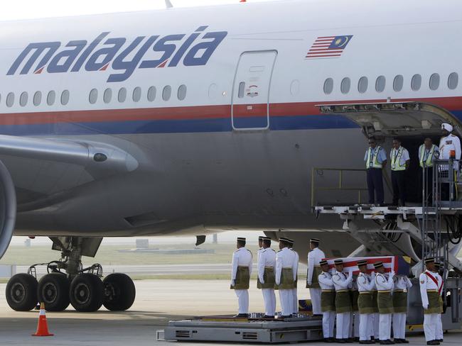 Malaysian Army soldiers carry a coffin containing the body of Mohd Ghafar Abu Bakar, a Malaysia Airlines in-flight supervisor who was among the victims on board Flight MH17. Picture: Lai Seng Sin