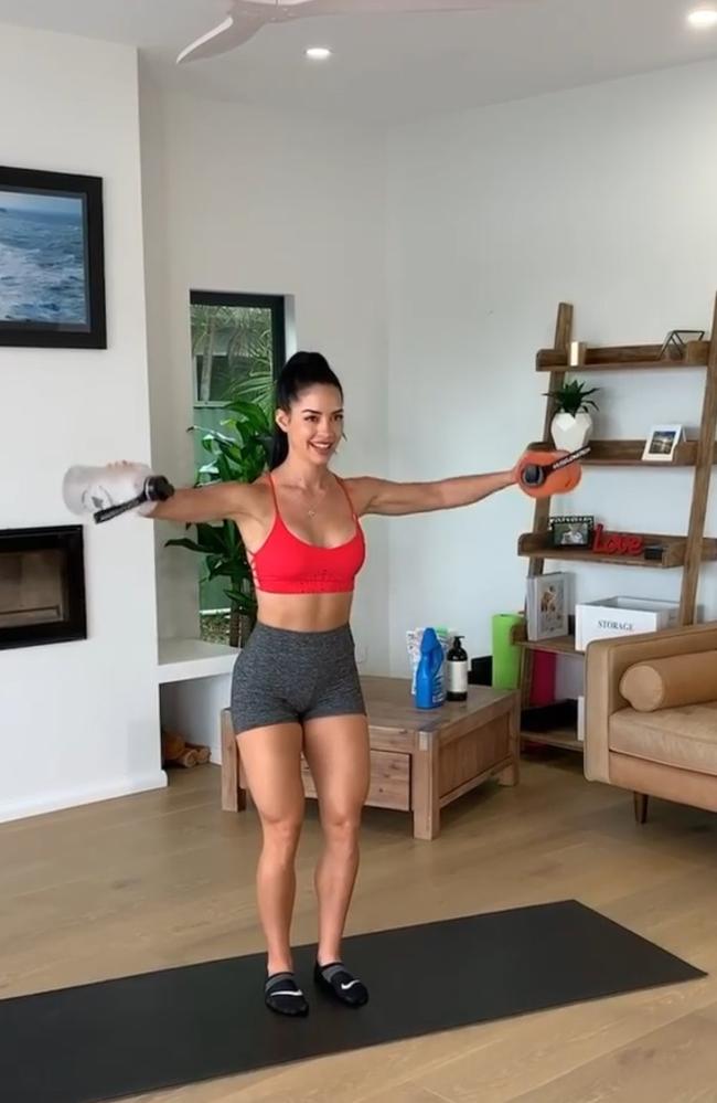 Here she is using water bottles as dumbbells. Picture: Instagram/RachelDillon