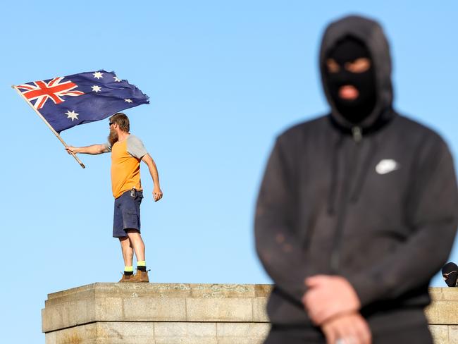 A man waves an Australian flag at the Shrine of Remembrance. Picture: Ian Currie