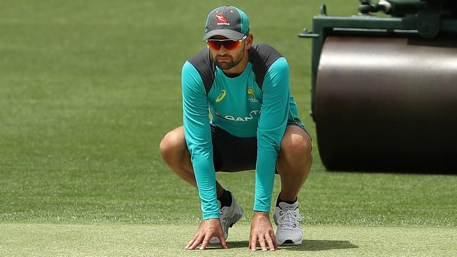 Australian spinner Nathan Lyon checks out the Gabba wicket yesterday