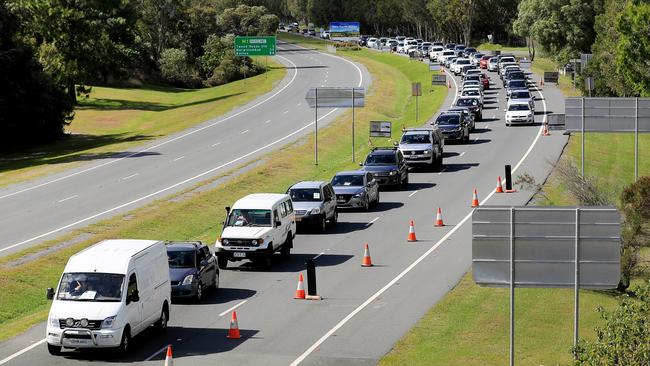 Motorists lining up to pass a border checkpoint on the Gold Coast Highway at Coolangatta. Picture: Scott Powick