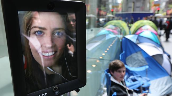 Lucy the robot is first in line. People waiting outside the Apple store in George St for the new iPhone to go on sale tomorrow. Photo: Bob Barker.