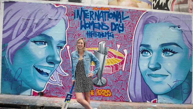 Australian cricketer Ellyse Perry with a mural in Hosier Lane depicting her and pop singer Katy Perry in the lead-up to the ICC Women’s T20 World Cup on March 8. Picture: Ian Currie