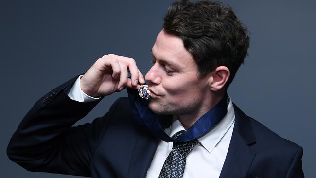 Lions midfielder Lachie Neale poses with the Brownlow Medal at the Gabba Picture: Getty Images