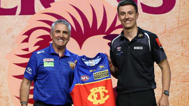 Brisbane Lions head coach Chris Fagan presents Hugh McCluggage with his jumper. Picture: Getty Images