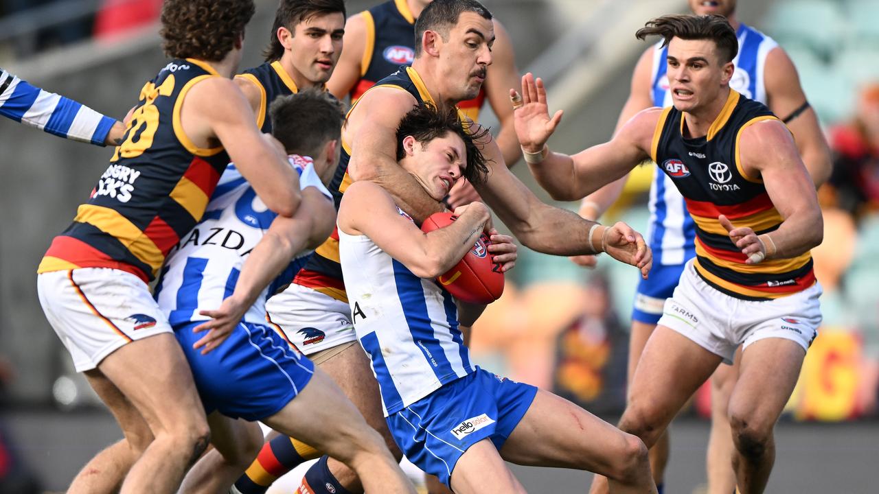 HOBART, AUSTRALIA: Taylor Walker of the Crows tackles Kayne Turner of the Kangaroos during the round 15 AFL match between the North Melbourne Kangaroos and the Adelaide Crows at Blundstone Arena on June 26, 2022 in Hobart, Australia. (Photo by Steve Bell/Getty Images)