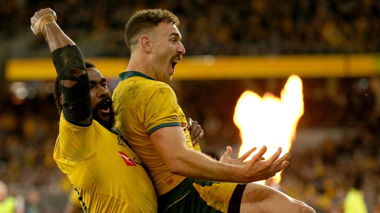 Marika Koroibete and Nic White of the Wallabies celebrate a try.