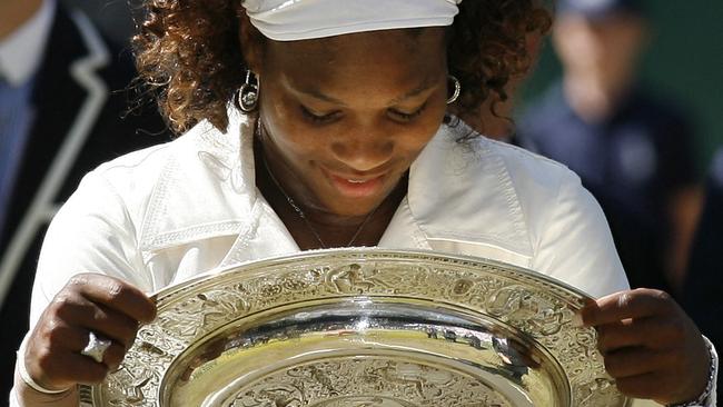 US Serena Williams holds the trophy after defeating her sister Venus Williams in the 2009 Wimbledon final. Picture: AFP