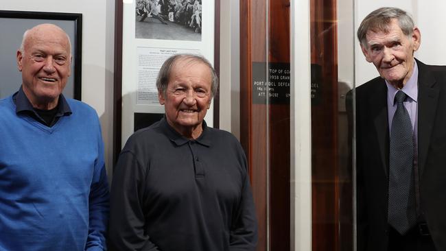 Ken Eustice, Ian Day and Peter Phipps with the goalpost that three Bloods players chopped down after a missed goal hit the post in the 1958 SANFL Grand Final. Picture: Dylan Coker