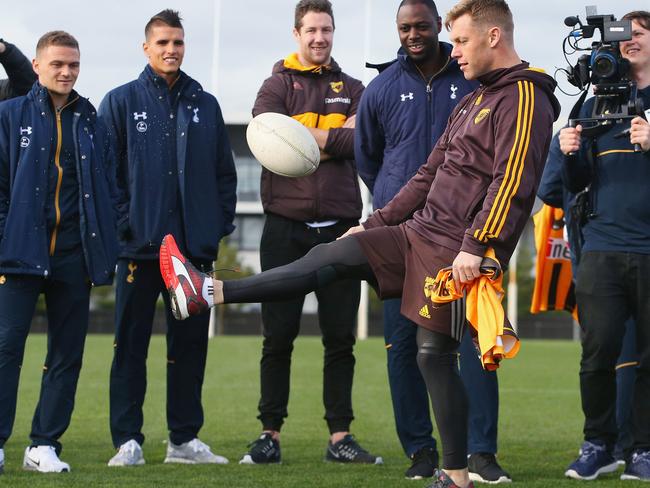 MELBOURNE, AUSTRALIA - JULY 27:  Retired Spurs captain Ledley King watches Sam Mitchell of the Hawks dribble an AFL Football during a Tottenham Hotspur player visit to the Hawthorn Hawks AFL team at Waverley Park on July 27, 2016 in Melbourne, Australia.  (Photo by Michael Dodge/Getty Images)