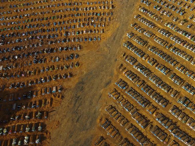 This file photograph taken on November 21, 2020, shows an aerial view of the burial site reserved for victims of the COVID pandemic at the Nossa Senhora Aparecida cemetery in Manaus, in the Amazon forest in Brazil. - The Covid-19 pandemic, which for over three years has killed millions of people, wreaked economic havoc and deepened inequalities, no longer constitutes a global health emergency, the WHO said on May 5, 2023. It is "with great hope that I declare Covid-19 over as a global health emergency", WHO chief Tedros Adhanom Ghebreyesus told reporters, estimating that the pandemic had killed "at least 20 million" people, nearly three times the official estimate. (Photo by MICHAEL DANTAS / AFP)