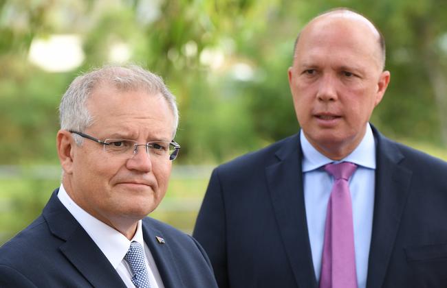 Prime Minister Scott Morrison and Minister for Home Affairs Peter Dutton at Bald Hills, Brisbane, yesterday. Picture: AAP/Dave Hunt