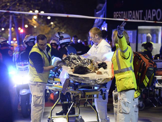 Rescuers evacuate an injured person near the Bataclan concert hall. AFP: Miguel Medina.