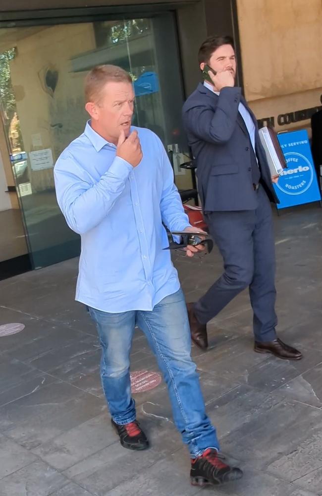 Andrew William Campbell (left, wearing a blue shirt and jeans) leaving Ipswich Magistrates Court with his lawyer Hugh Stitt (right) on July 21, 2023. Picture: Nicola McNamara