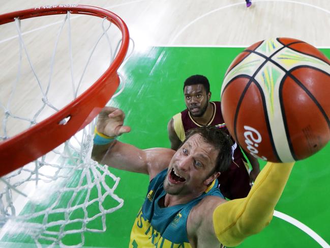 Australia's David Andersen drives to the basket past Venezuela's Nestor Colmenares, rear, during a basketball game at the 2016 Summer Olympics in Rio de Janeiro, Brazil, Sunday, Aug. 14, 2016. (AP Photo/Charlie Neibergall)