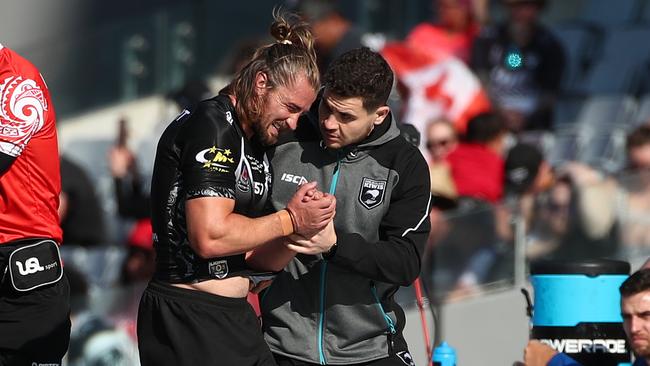 Kieran Foran clutches at his injury shoulder. Picture: Fiona Goodall/Getty