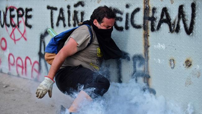 A demonstrator clashes with riot police during a protest against the government in Santiago in Chile. Picture: AFP