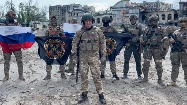 Yevgeny Prigozhin (front) pictured with Wagner Group mercenaries in Bakhmut, Ukraine. Picture: AFP