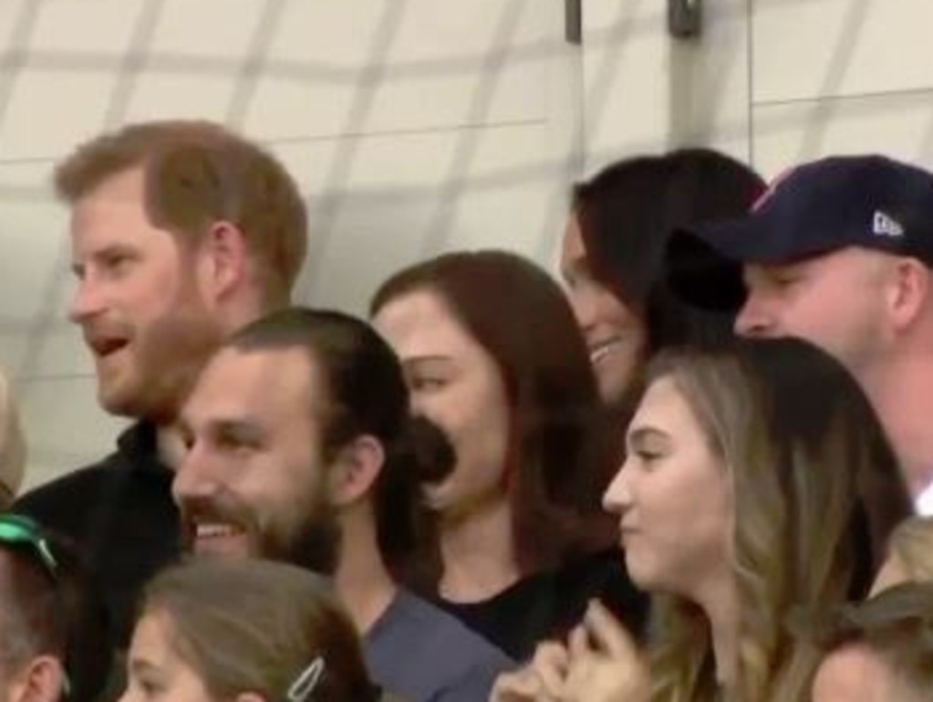 Meghan tries to get Harry’s attention. Picture: Supplied