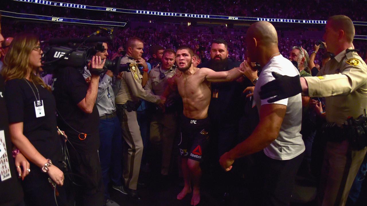 Khabib Nurmagomedov of Russia is escorted out of the arena.