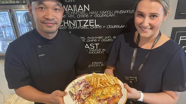 Chef Putu Ernawan and The Coach Ringwood’s Renee Condello with one of the venue's massive chicken parmas, which come in 13 flavours. Picture: Kiel Egging.