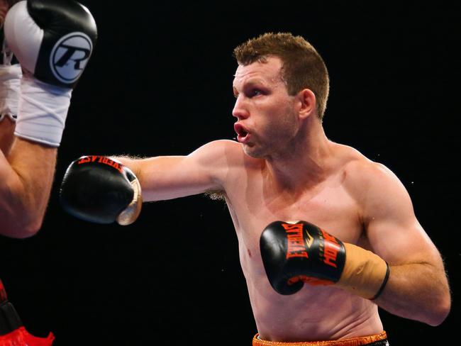 Australian boxer Jeff Horn (R) and English boxer Gary Corcoran (L) fight during their World Boxing Organisation welterweight title bout at Brisbane Convention Centre in Brisbane on December 13, 2017. Australian Jeff Horn retained his World Boxing Organisation welterweight title with an 11th round TKO win over English challenger Gary Corcoran in Brisbane on December 13. / AFP PHOTO / Patrick HAMILTON / -- IMAGE RESTRICTED TO EDITORIAL USE - STRICTLY NO COMMERCIAL USE --