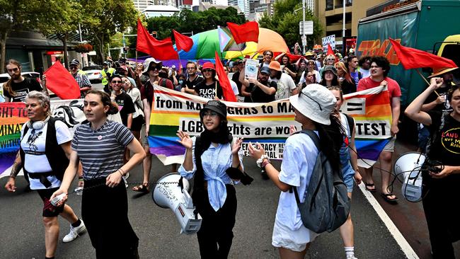 Protesters march with flags and banners at a rally in front of St Mary’s Cathedral during the funeral of Cardinal George Pell AFP. Picture: AFP