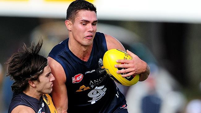 South Aelaide’s Lachlan Boyd caught in a tackle by Glenelg&#39;s Max Proud. Boyd’s should was