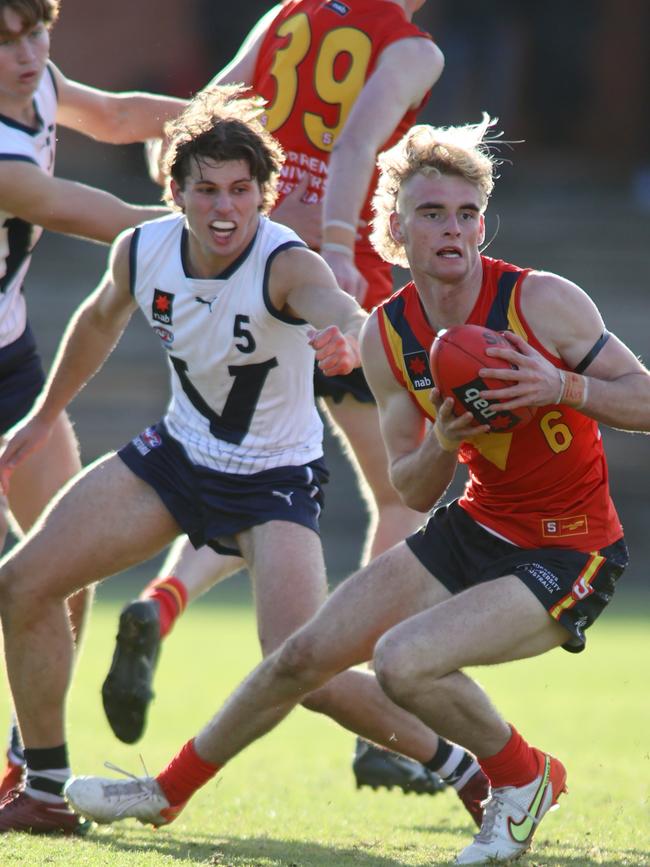 Jakob Ryan of South Australia evades Jhye Clark of Victoria Country during the U18 AFL Boys Championship. Picture: Kelly Barnes/Getty Images