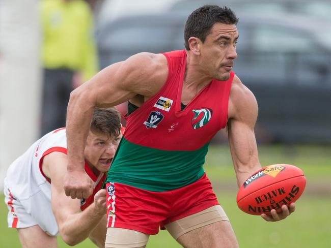 Peninsula Football League round 11 action between Karingal and Pines. Karingal 12. 8 (80) were defeated by Pines 17. 12 (114). Karingal's Tom Wilkinson tries in vain to stop Pines strong man Paul Scanlon. Picture: Gary Bradshaw