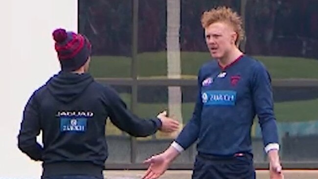 Melbourne midfielder Clayton Oliver in a heated discussion with a Dees trainer on Wednesday.