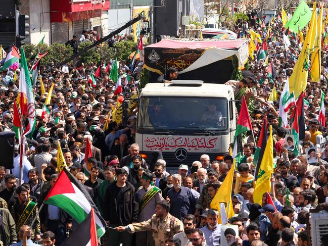 Thousands of Iranians attend the funeral procession for seven Islamic Revolutionary Guard Corps members killed in a strike in Syria. Picture: AFP.