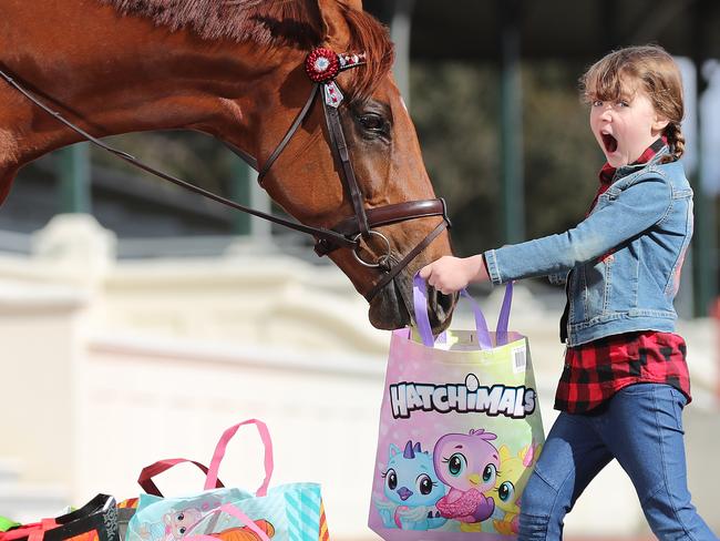 The Royal Melbourne Showbags, with Patrick the Show Jumping horse annoying Veronica, 5, at the Royal Melbourne Showgrounds.  Picture: Alex Coppel