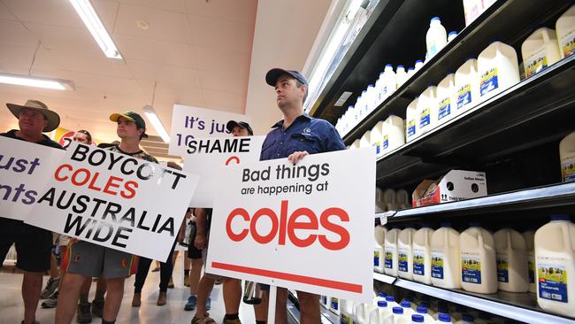 Queensland dairy farmers protest inside a Coles supermarket store in March 2019. The farmers were protesting against the $1 per litre milk sold under the Coles brand. Picture: Dan Peled/AAP