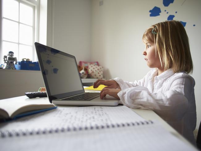 f34bully. Girl Using Laptop In Bedroom. generic for edu story on cyber bullying.Thinkstock