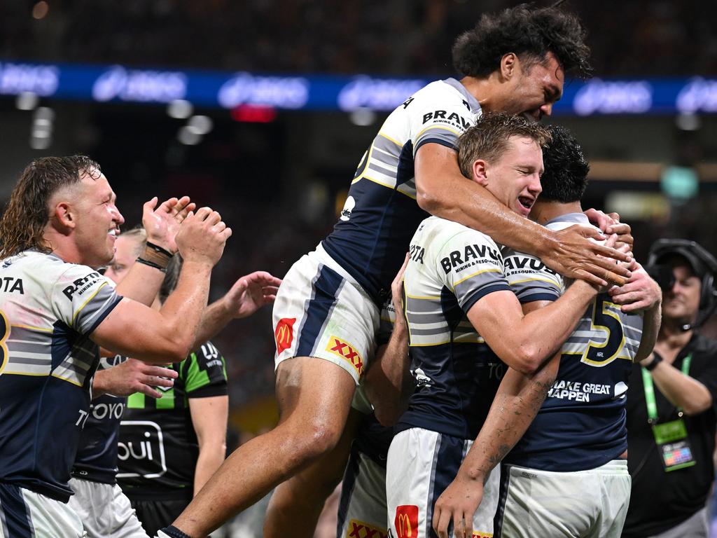 Murray Taulagi is mobbed by his Cowboys teammates after scoring in the corner. Picture: Getty Images