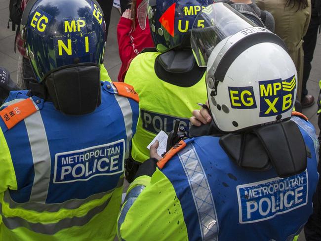 LONDON, ENGLAND - MAY 09: Anti-government protestors are surrounded by police officers during a protest on Whitehall on May 9, 2015 in London, England. After the United Kingdom went to the polls on Thursday the Conservative party were confirmed as the winners of a closely fought general election which has returned David Cameron as Prime Minister with a slender majority for his party. (Photo by Rob Stothard/Getty Images)