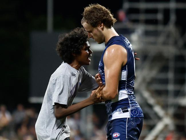 A spectator runs onto the field to Jake Kolodjashnij. Picture: Michael Willson/AFL Photos via Getty Images