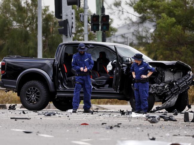 Police examine debris with the wrecked Raptor behind them. Picture: Sam Ruttyn