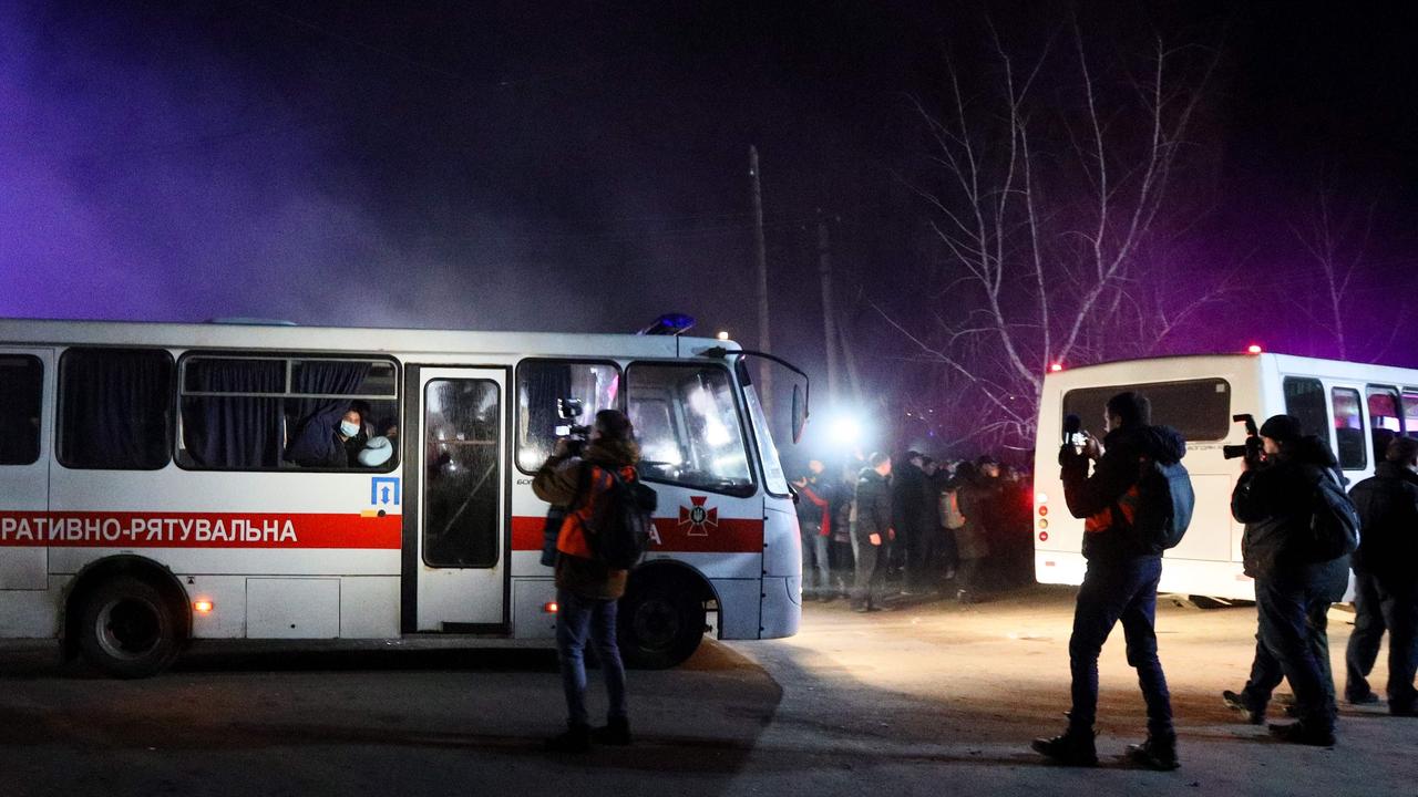 Buses carrying evacuees from coronavirus-hit China drive to a medical facility in the settlement of Novi Sanzhary, Ukraine, on February 20, 2020. Picture: STR/AFP