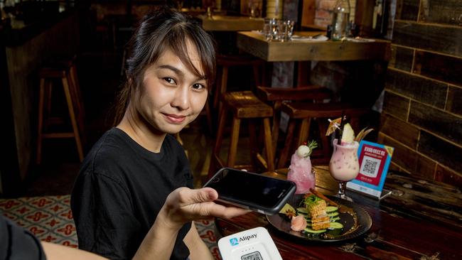 IncentiaPay is rolling out Chinese mobile payment method Alipay on the Gold Coast. Nopphaket Maleenant pays for her meal at Chong Co Thai Pacific Fair with Alipay. Picture: Jerad Williams