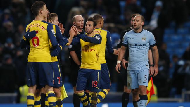 Arsenal's Santi Cazorla, second right No19, celebrates with his teammates at the end of the English Premier League soccer match between Manchester City and Arsenal at the Etihad Stadium, Manchester, England, Sunday, Jan. 18, 2015. Arsenal won the match 2-0, with Cazorla and his teammate Arsenal's Olivier Giroud scoring the goal.(AP Photo/Jon Super)