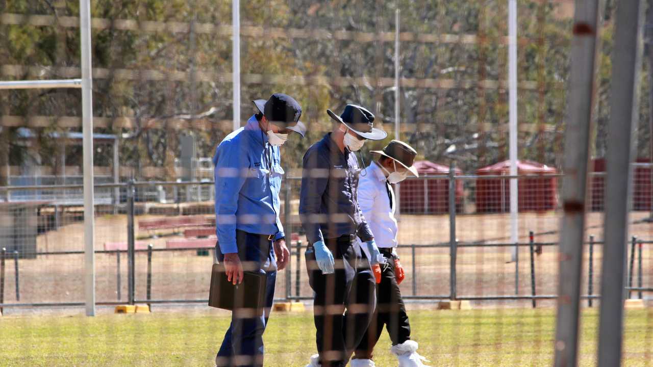 Asbestos Removal Queensland workers and Southern Downs Regional Council staff survey the Collegians Junior Rugby League football field after soil testing confirmed positive traces of asbestos. Picture: Marian Faa
