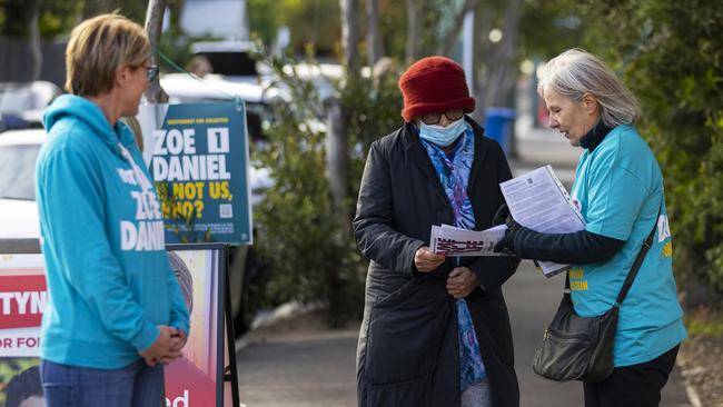 Independent candidate for Goldstein Zoe Daniel (L) speaks to voters at a pre-polling centre in Hampton.