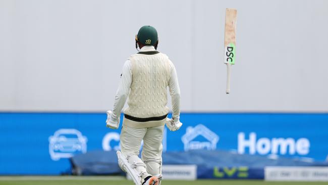 Usman Khawaja throws his bat in the air while celebrating his century. Picture: Getty