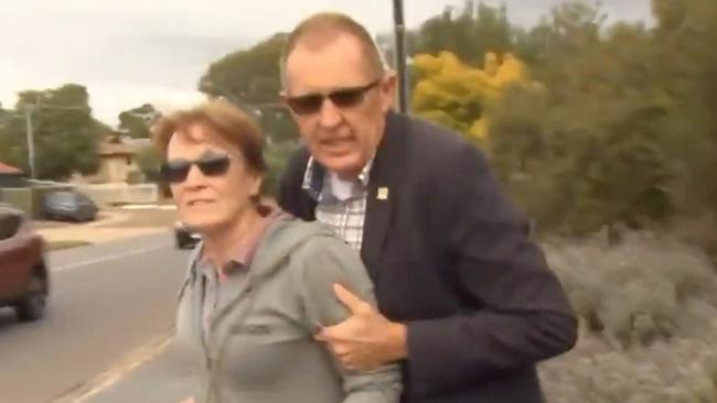 Tea Tree Gully Mayor Kevin Knight and his wife attempted to escape the media on Monday following renewed calls for his resignation. Picture: 7 News