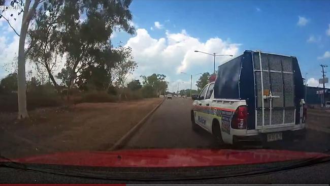 A cop car has narrowly avoided colliding with a Darwin motorist on the Stuart Hwy. Video: Brett Perry