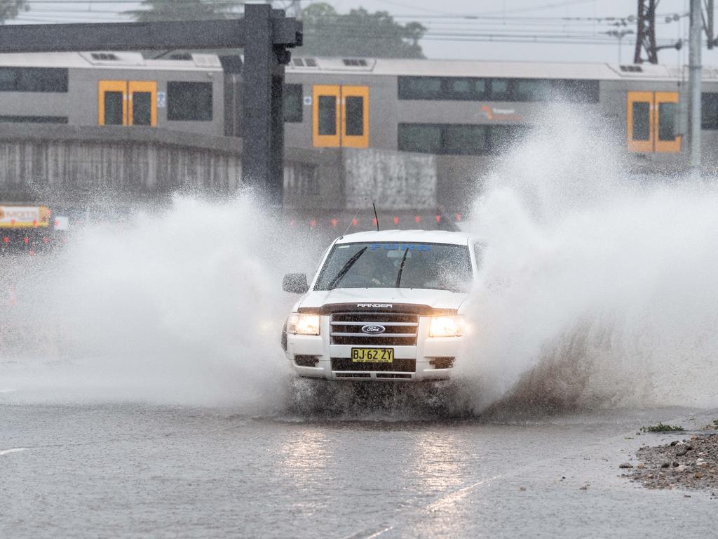 Vehicles brave the wet conditions in Penrith, western Sydney, on Saturday. Picture: Monique Harmer.